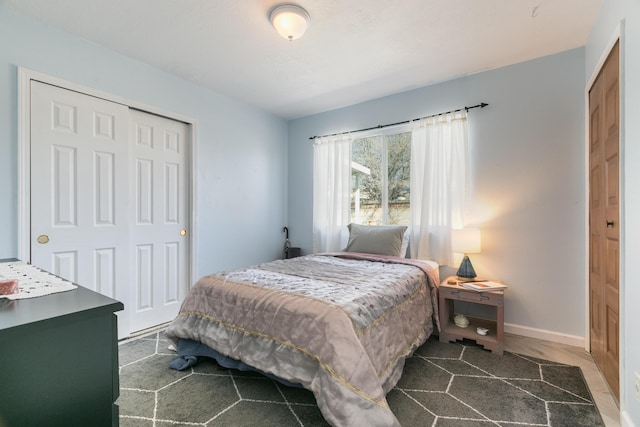 bedroom with a closet and baseboards