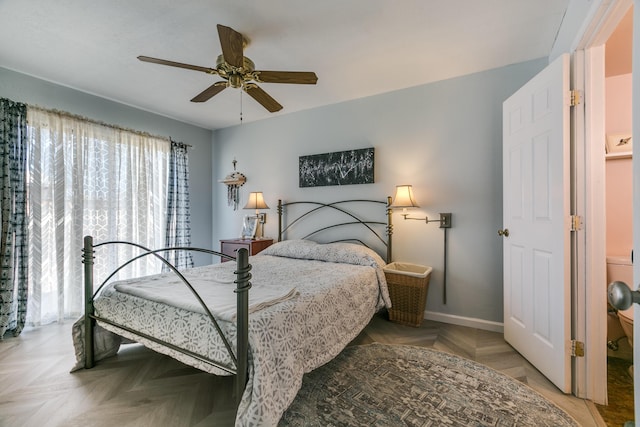 bedroom featuring baseboards and ceiling fan