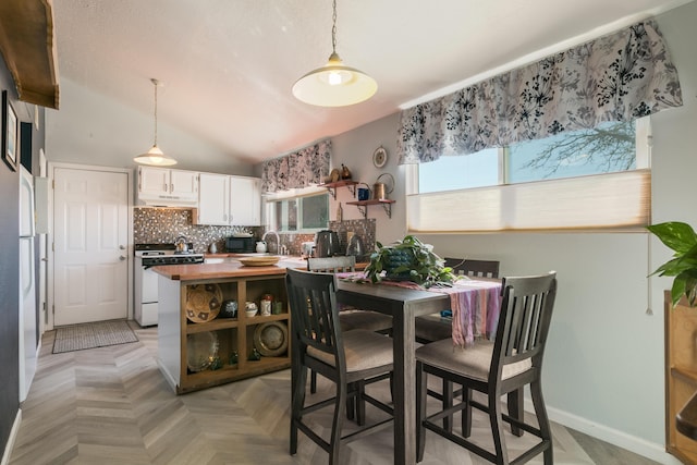 interior space with baseboards and vaulted ceiling