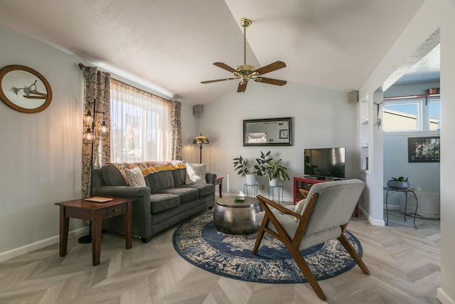 living area with vaulted ceiling, plenty of natural light, baseboards, and ceiling fan