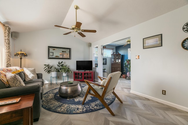 living room with baseboards, ceiling fan, and vaulted ceiling