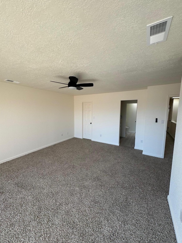 spare room with visible vents, carpet floors, baseboards, and ceiling fan