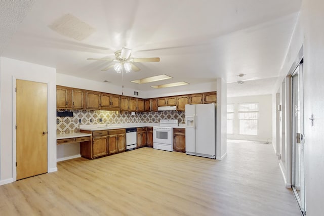 kitchen featuring white appliances, a ceiling fan, decorative backsplash, light countertops, and brown cabinets