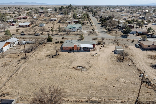 birds eye view of property with a mountain view and a desert view