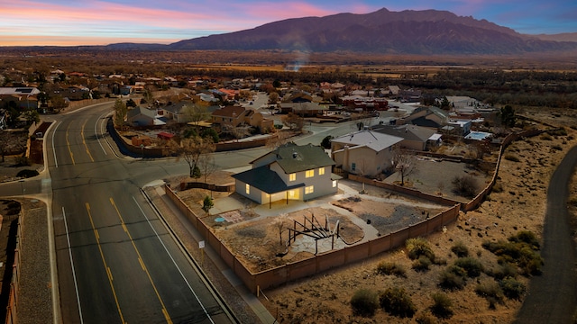 aerial view at dusk with a mountain view and a residential view