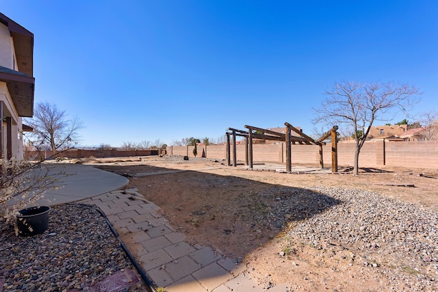 view of yard with a patio area, a pergola, and a fenced backyard