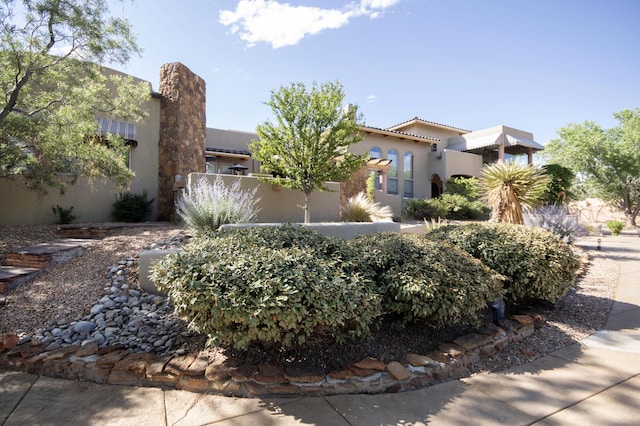 view of front of home featuring stucco siding and fence