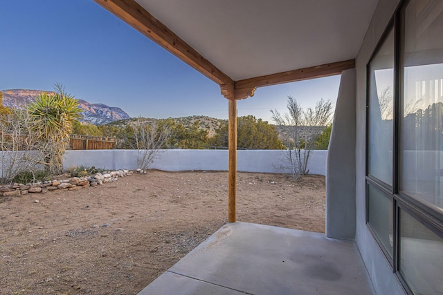 view of yard with a patio area, a mountain view, and a fenced backyard