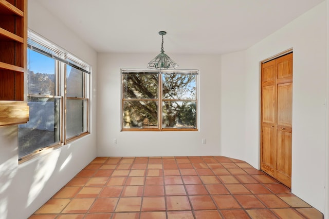 unfurnished dining area with light tile patterned flooring