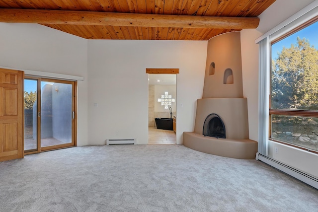 unfurnished living room featuring a baseboard radiator, a large fireplace, and beam ceiling