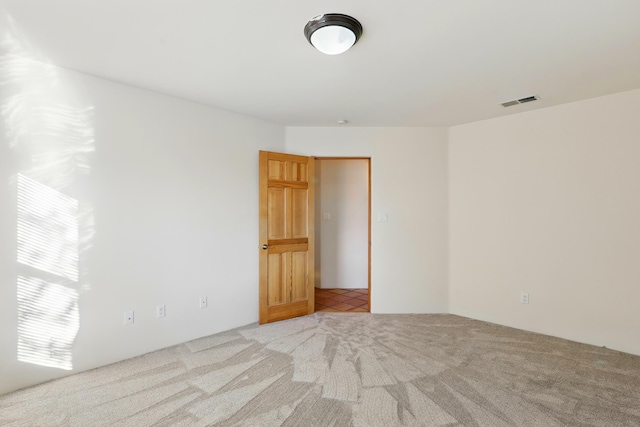 unfurnished room with visible vents and carpet floors