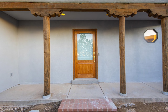 entrance to property featuring stucco siding