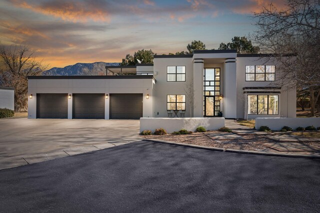 modern home featuring stucco siding, concrete driveway, and a garage