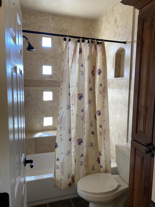 full bathroom with toilet, shower / tub combo, and tile patterned flooring