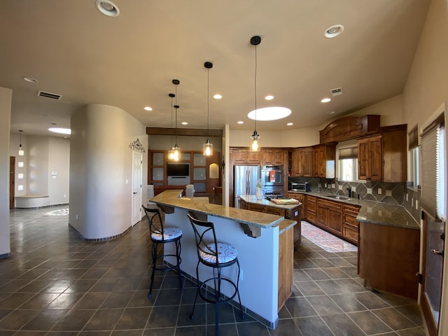 761 Marble Sky Ave NE, Rio Rancho, NM 87144 - kitchen with a large island, a sink, recessed lighting, decorative backsplash, and appliances with stainless steel finishes