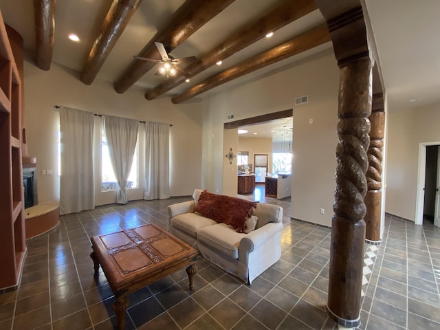 761 Marble Sky Ave NE, Rio Rancho, NM 87144 - tiled living area with beamed ceiling, a ceiling fan, a glass covered fireplace, ornate columns, and recessed lighting