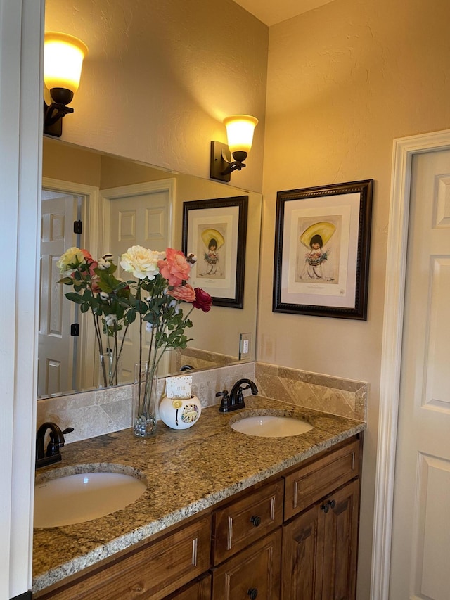 bathroom featuring double vanity and a sink