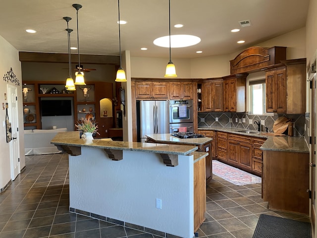 kitchen with dark tile patterned floors, visible vents, appliances with stainless steel finishes, and a kitchen island