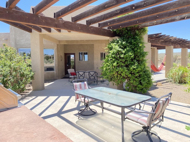 view of patio with outdoor dining area and a pergola