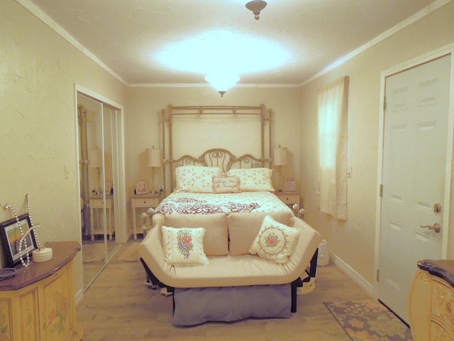 bedroom with light wood-type flooring, crown molding, and baseboards