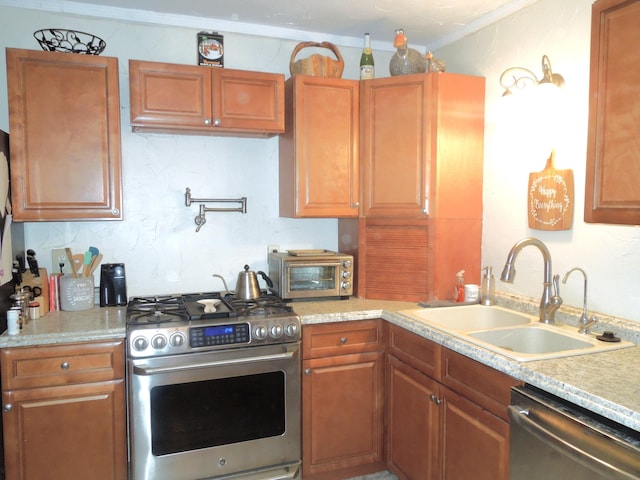 kitchen with a toaster, stainless steel appliances, light countertops, and a sink