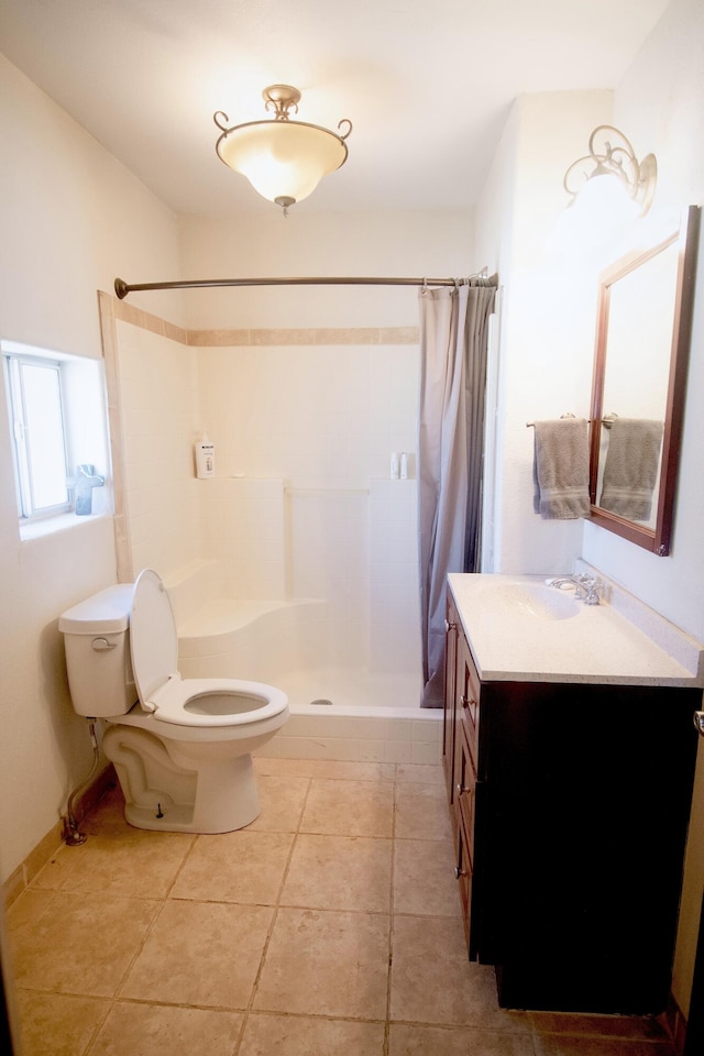 full bath with vanity, toilet, a stall shower, and tile patterned flooring