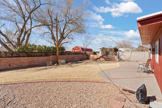 view of yard with a fenced backyard and a patio area