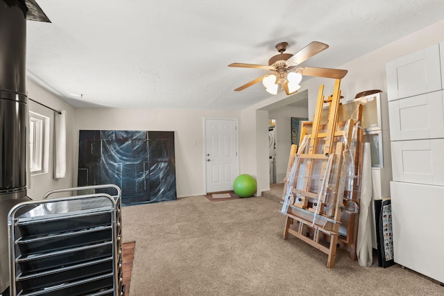 workout room with carpet floors and ceiling fan