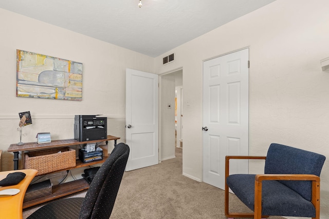 home office with light colored carpet and visible vents