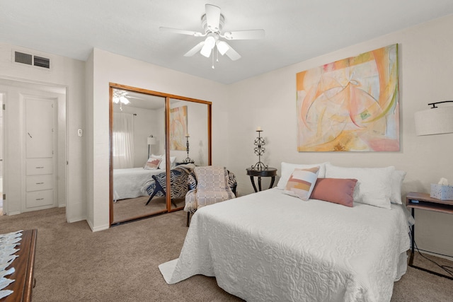 bedroom featuring visible vents, a closet, ceiling fan, and carpet flooring