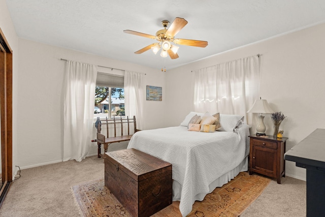 bedroom with baseboards, light carpet, and ceiling fan