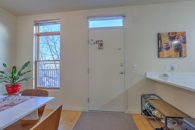 entrance foyer featuring plenty of natural light and light wood-style floors