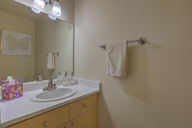 bathroom featuring toilet and vanity