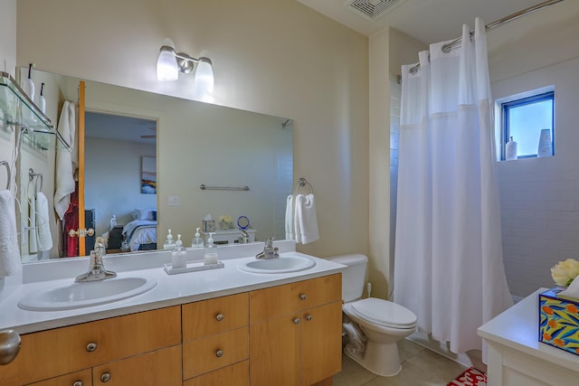 ensuite bathroom featuring a sink, connected bathroom, visible vents, and tile patterned floors