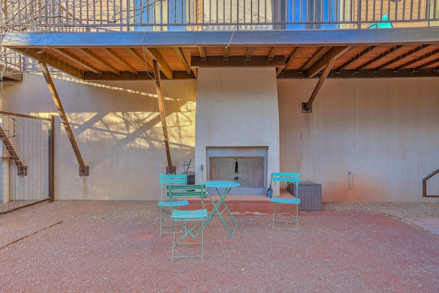 view of patio featuring a balcony and central AC