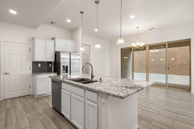 kitchen featuring white cabinets, visible vents, a sink, and appliances with stainless steel finishes