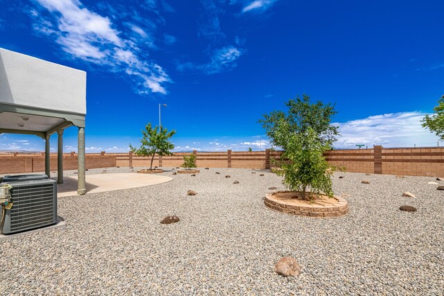 view of yard featuring a fenced backyard, a patio, and central AC