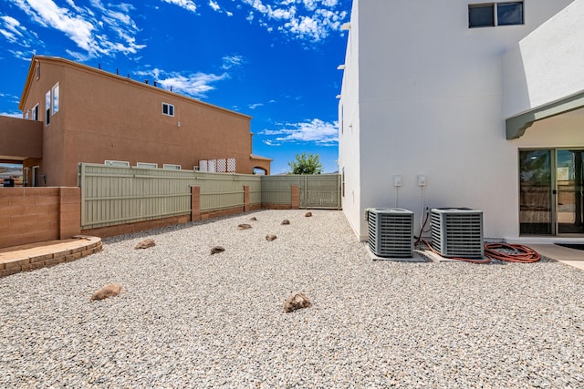 view of yard featuring cooling unit and fence