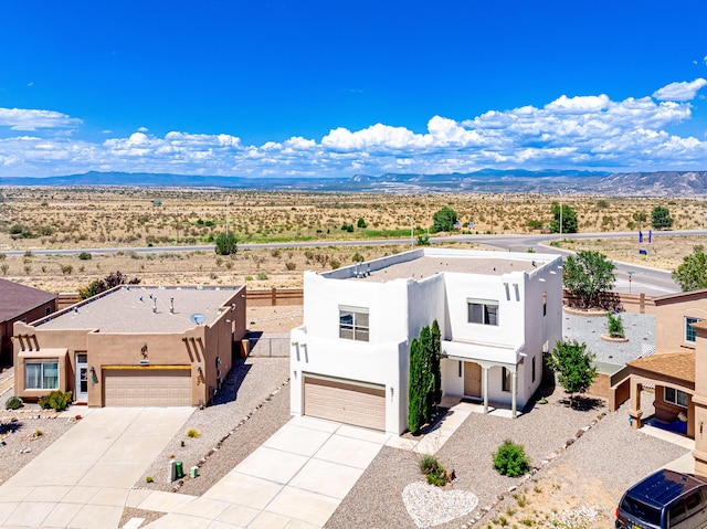 drone / aerial view featuring a mountain view and view of desert