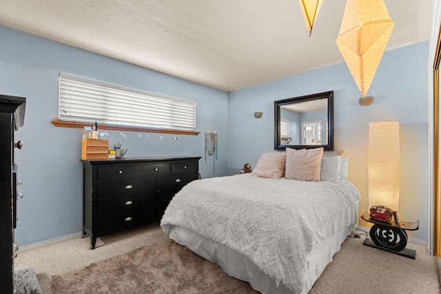 bedroom featuring carpet flooring, a textured ceiling, and baseboards