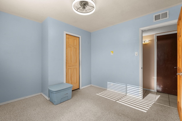 unfurnished room featuring visible vents, baseboards, and carpet