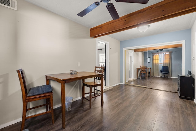 dining room with wood finished floors, a ceiling fan, visible vents, baseboards, and beamed ceiling