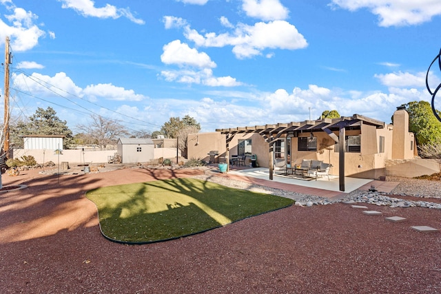 back of property with fence, stucco siding, an outdoor structure, a pergola, and a patio