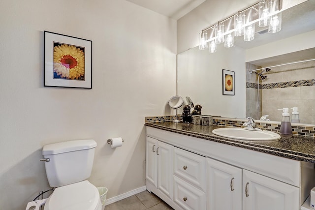 bathroom with toilet, tasteful backsplash, tile patterned flooring, baseboards, and vanity