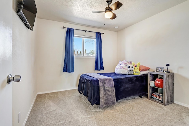 carpeted bedroom with baseboards, a textured ceiling, and ceiling fan