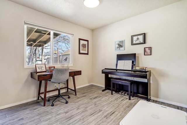 office space with baseboards and wood finished floors