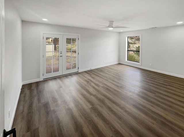 empty room with a ceiling fan, french doors, dark wood-style flooring, and baseboards