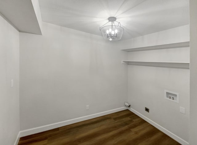 clothes washing area featuring washer hookup, laundry area, wood finished floors, and baseboards