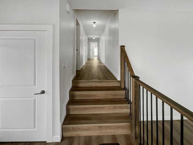 stairs with baseboards and wood finished floors