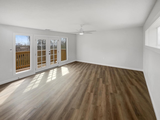 spare room with french doors, baseboards, visible vents, and wood finished floors